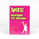 Spike mastering the kendama book front on with a white background